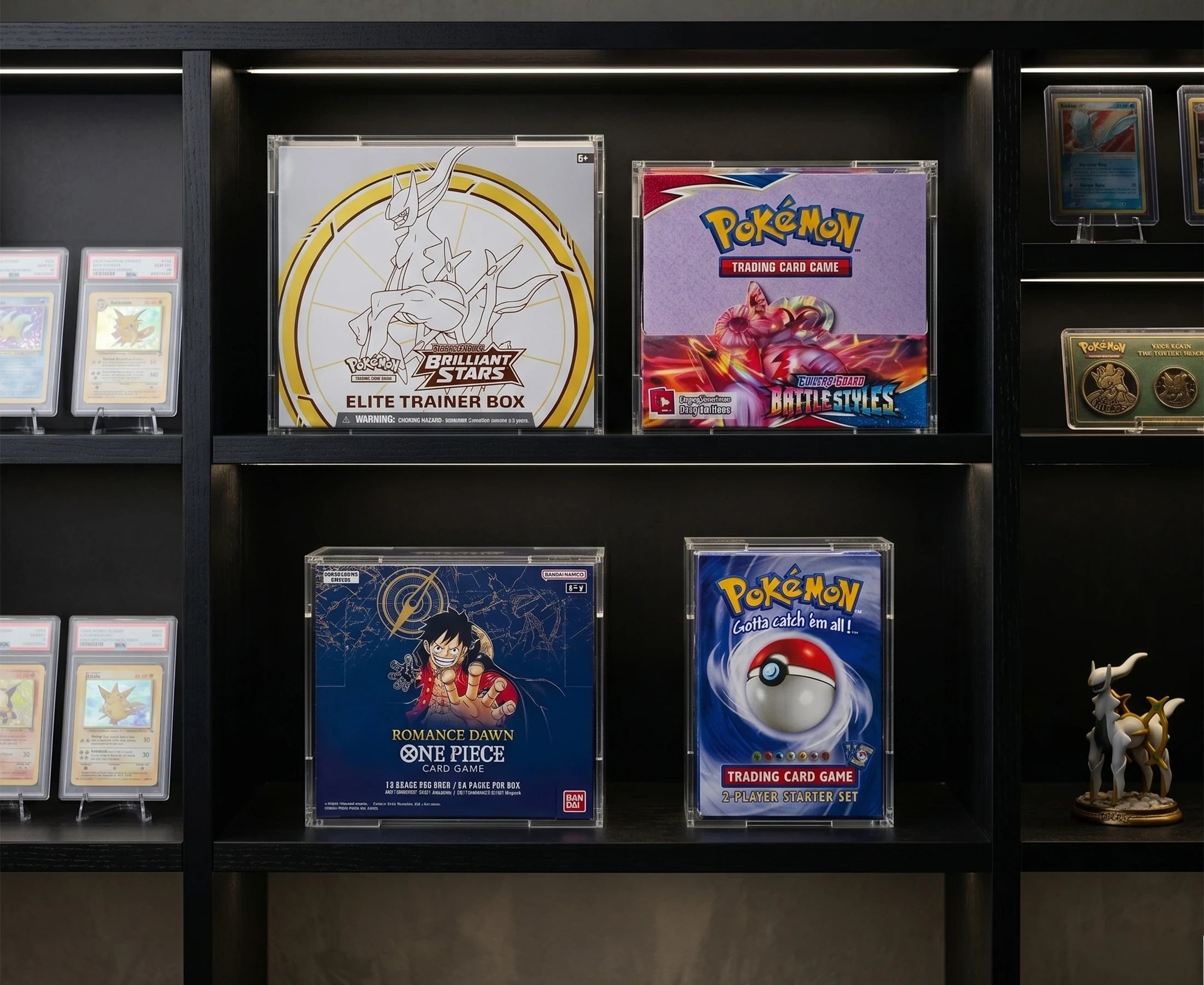 Pokémon acrylic display cases on a collector shelf